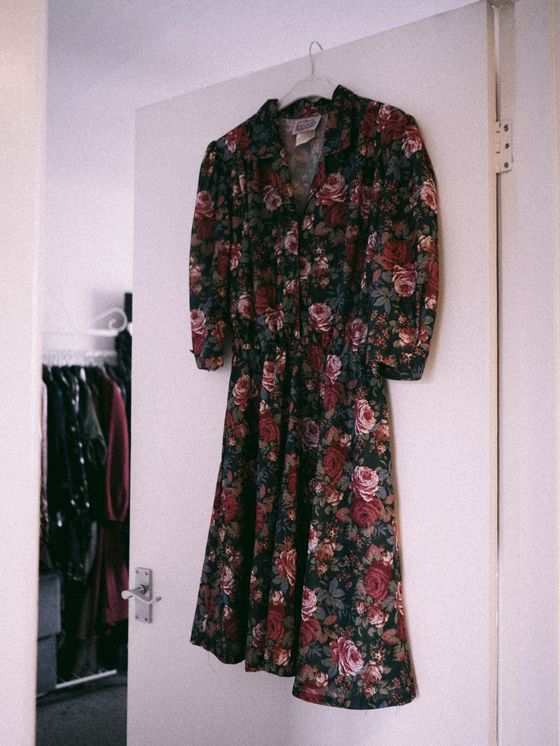 Vintage rose-print dress on a hanger